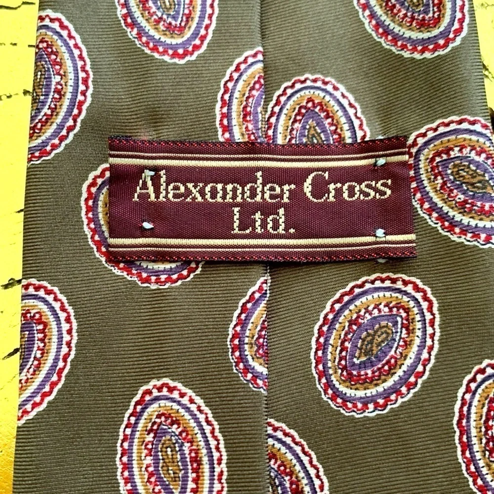 Alexander Cross Ltd Men’s Tie. 100% Silk. Base is Brown with Red & Blue Paisley